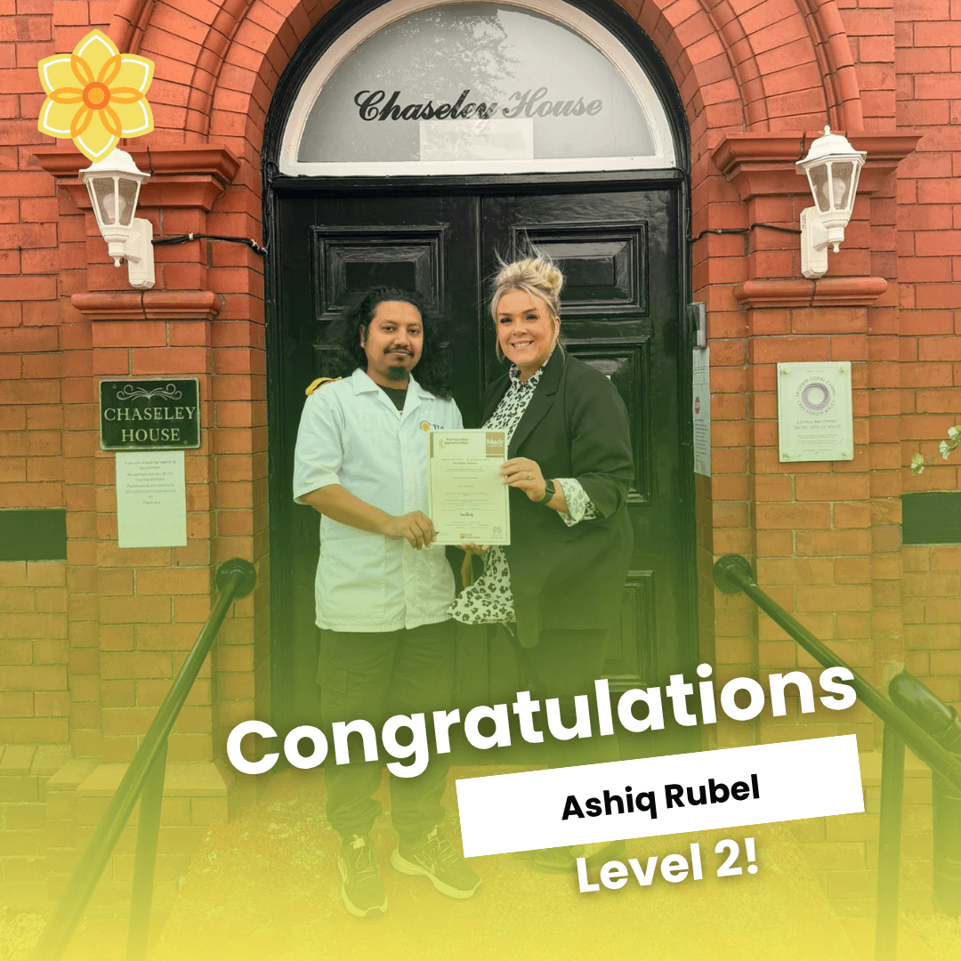 Congratulations Ashiq Rubel, Level 2: Ashiq being presented with the Level 2 Health and Social Care certificate by Assistant Manager Sophie Lowe outside Chaseley House
